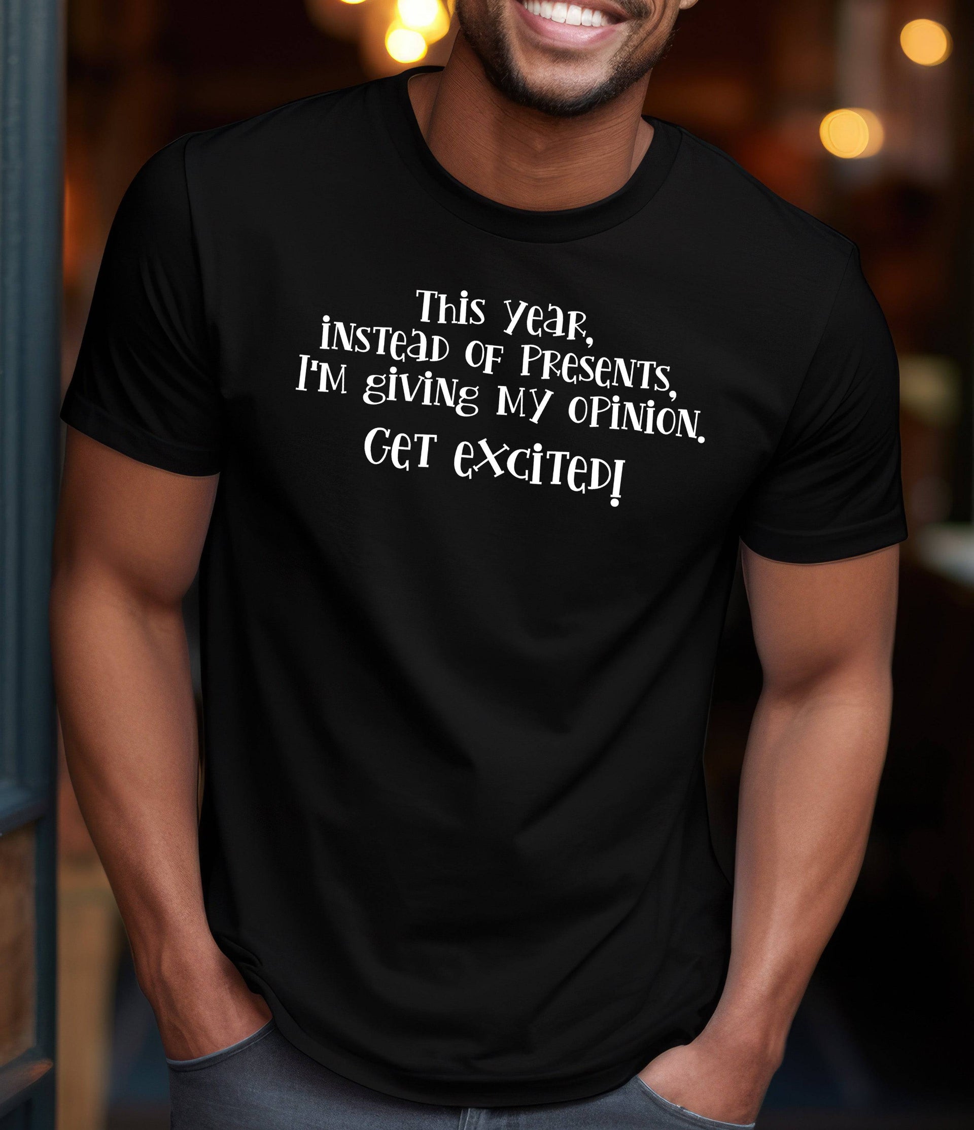 Man wearing a black t-shirt that says "This Year I'm Giving My Opinion, Get Excited."
