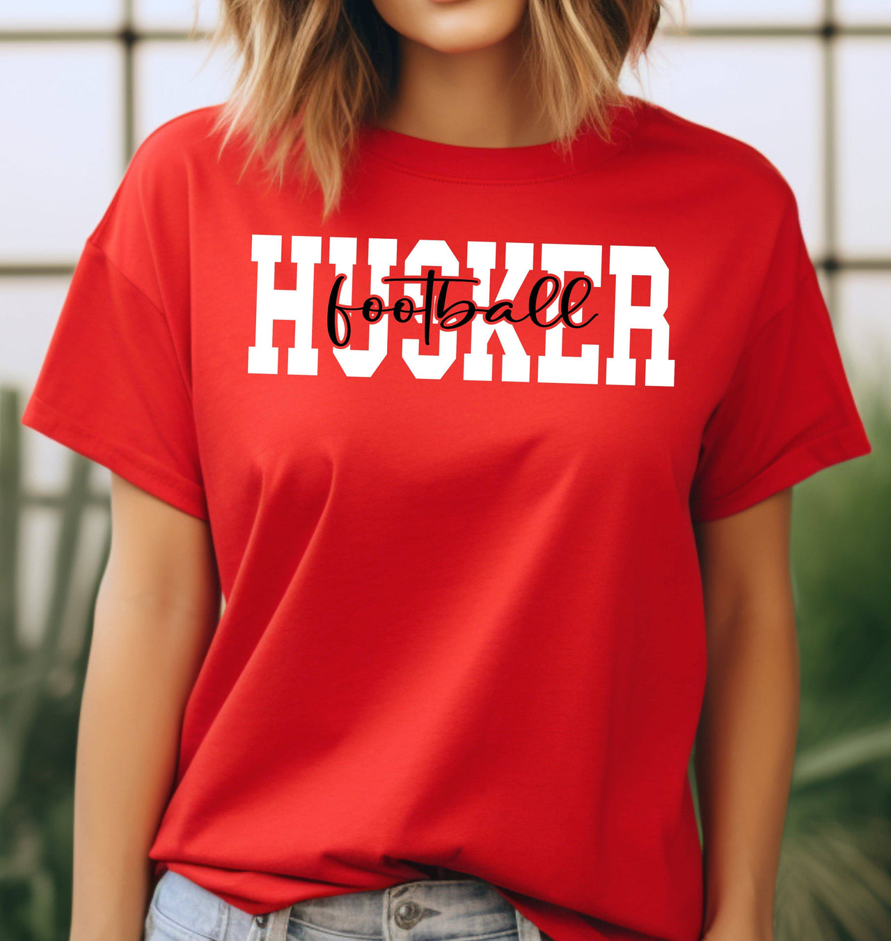 Woman wearing a red Husker Football t-shirt.