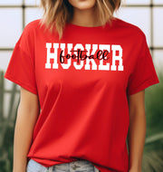 Woman wearing a red Husker Football t-shirt.