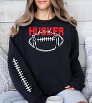 Woman wearing a black Husker Game Day crewneck sweatshirt.