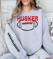 Woman wearing a sport grey Husker Game Day crewneck sweatshirt.