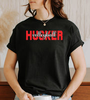 Person wearing a black t-shirt with 'Husker volleyball' text.