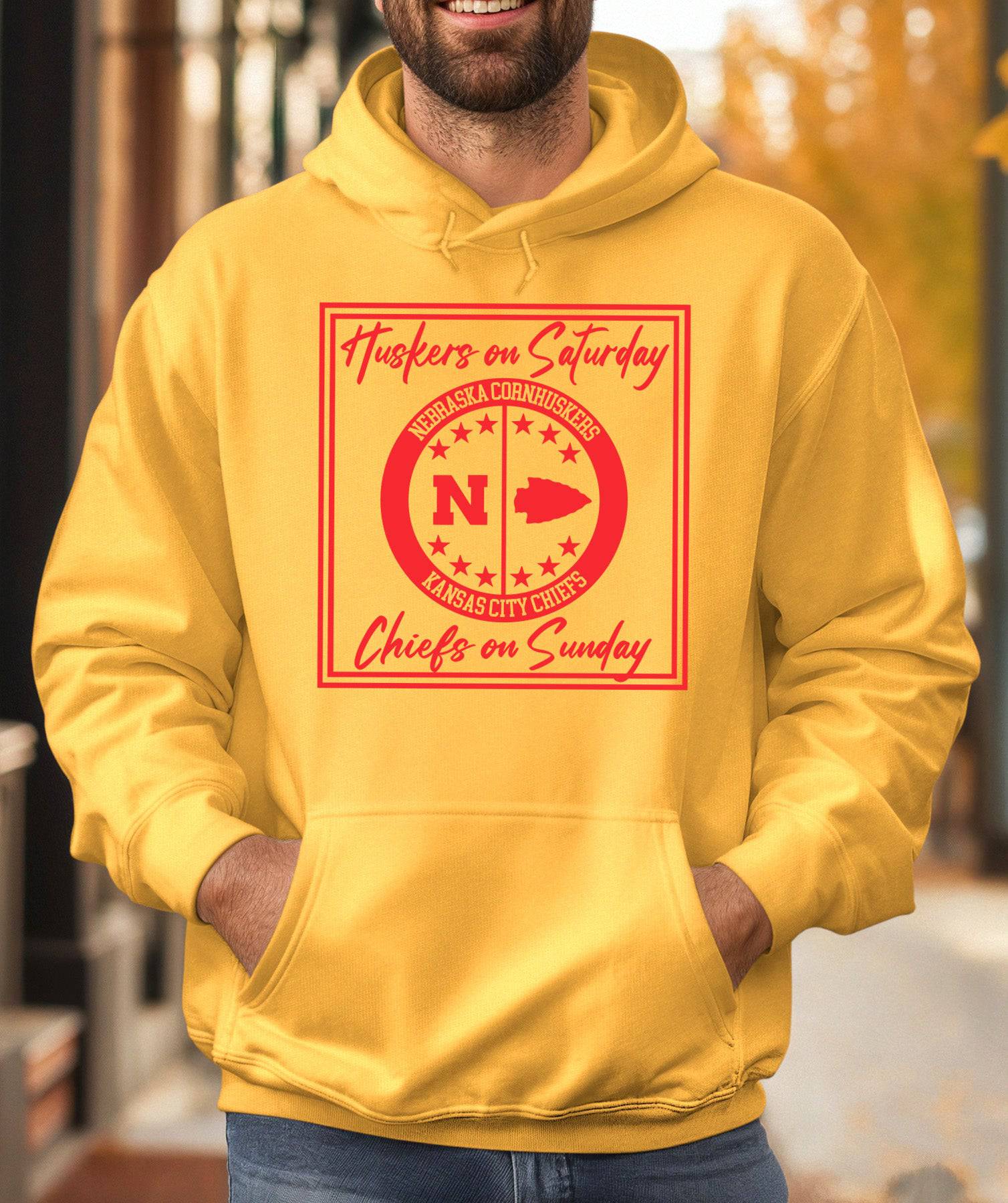 Man wearing a gold Huskers Chiefs hoodie sweatshirt.