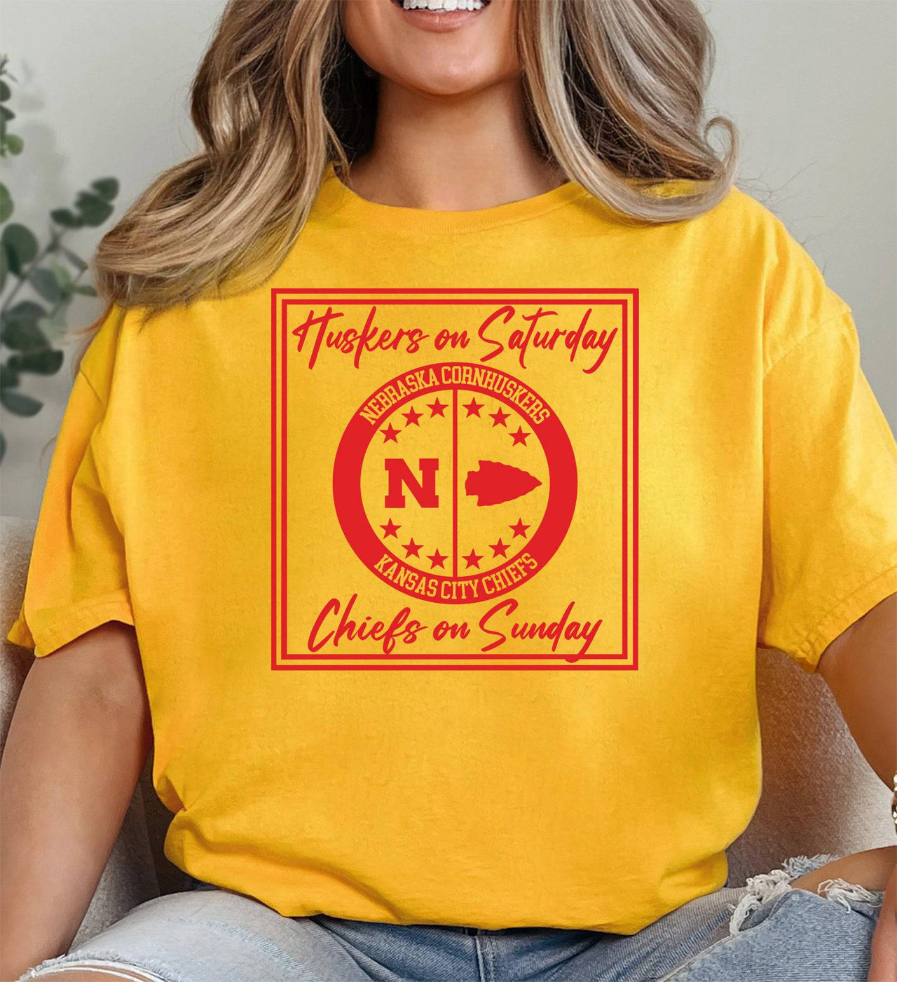 Woman wearing a gold Huskers Chiefs t-shirt.