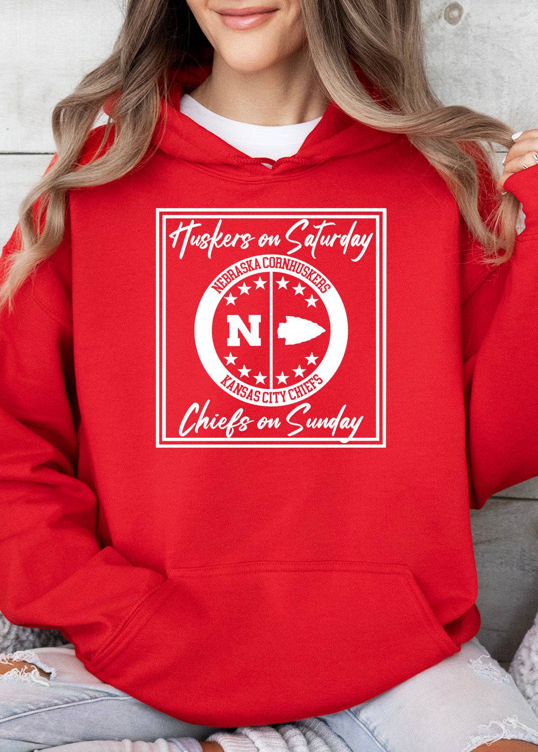Woman wearing a red Huskers Chiefs hoodie sweatshirt.