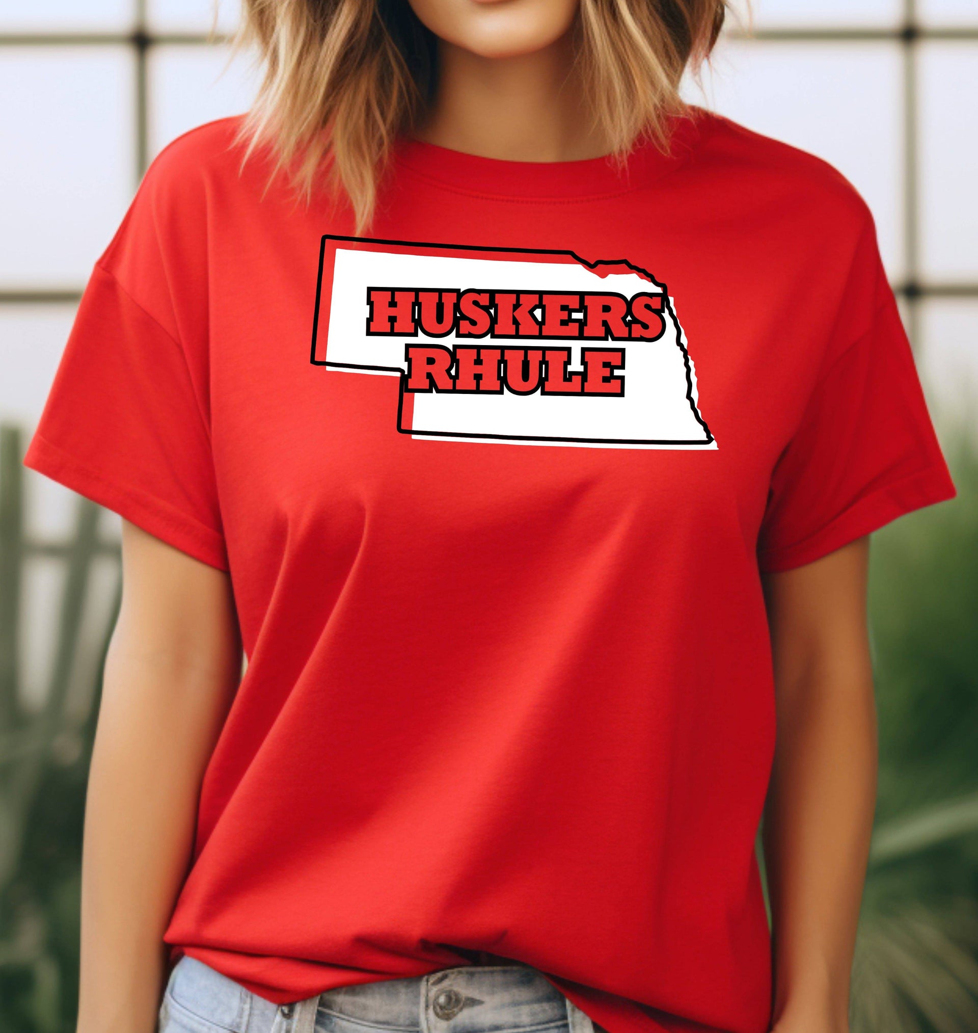 Woman wearing a red Huskers Rhule t-shirt.