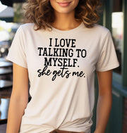 Woman wearing a sand t-shirt that says I Love Talking to Myself She Gets Me