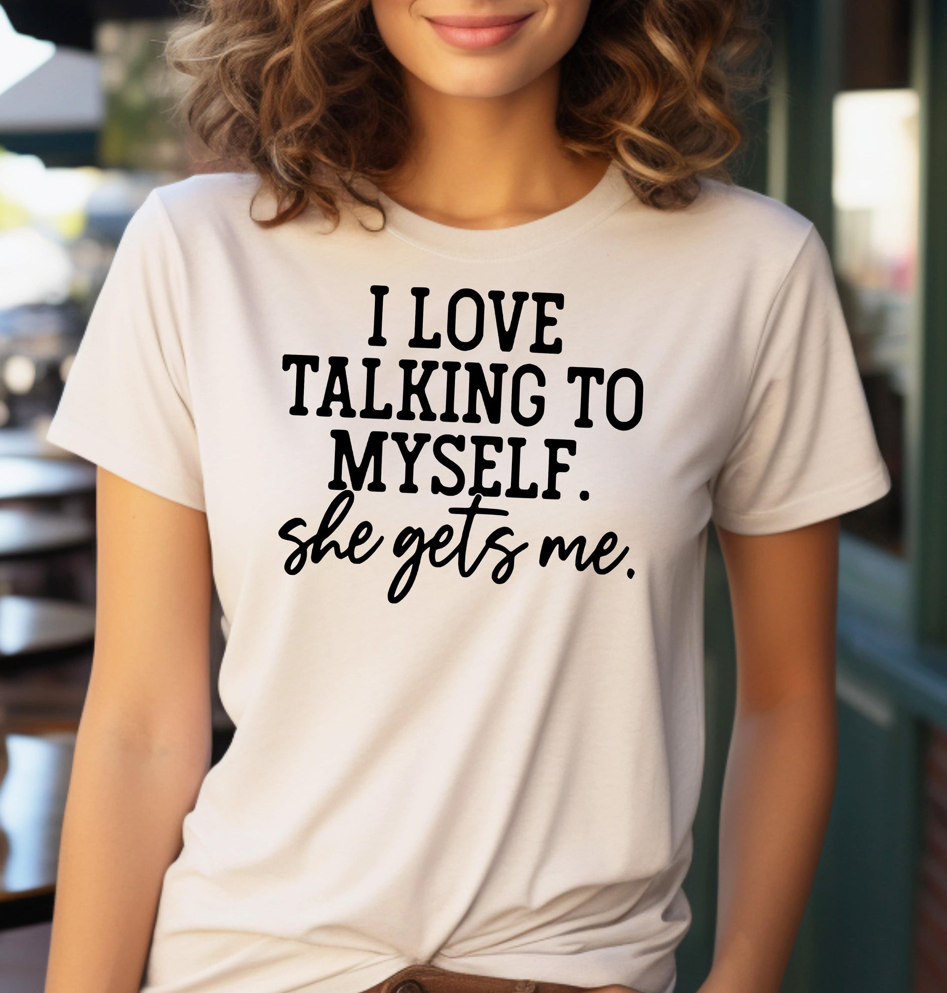 Woman wearing a sand t-shirt that says I Love Talking to Myself She Gets Me