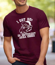 A man wearing a maroon t-shirt that says "I've Got Hos in Different Area Codes."