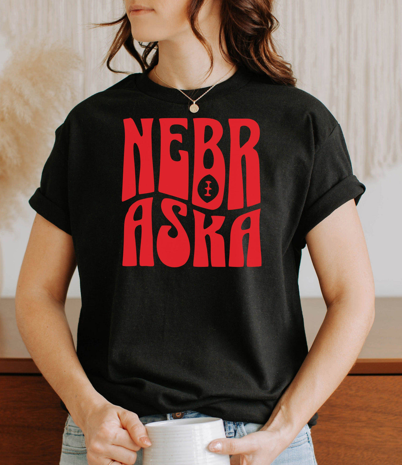 Woman wearing a retro Nebraska black t-shirt.