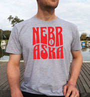 Man wearing a sport grey retro Nebraska t-shirt.