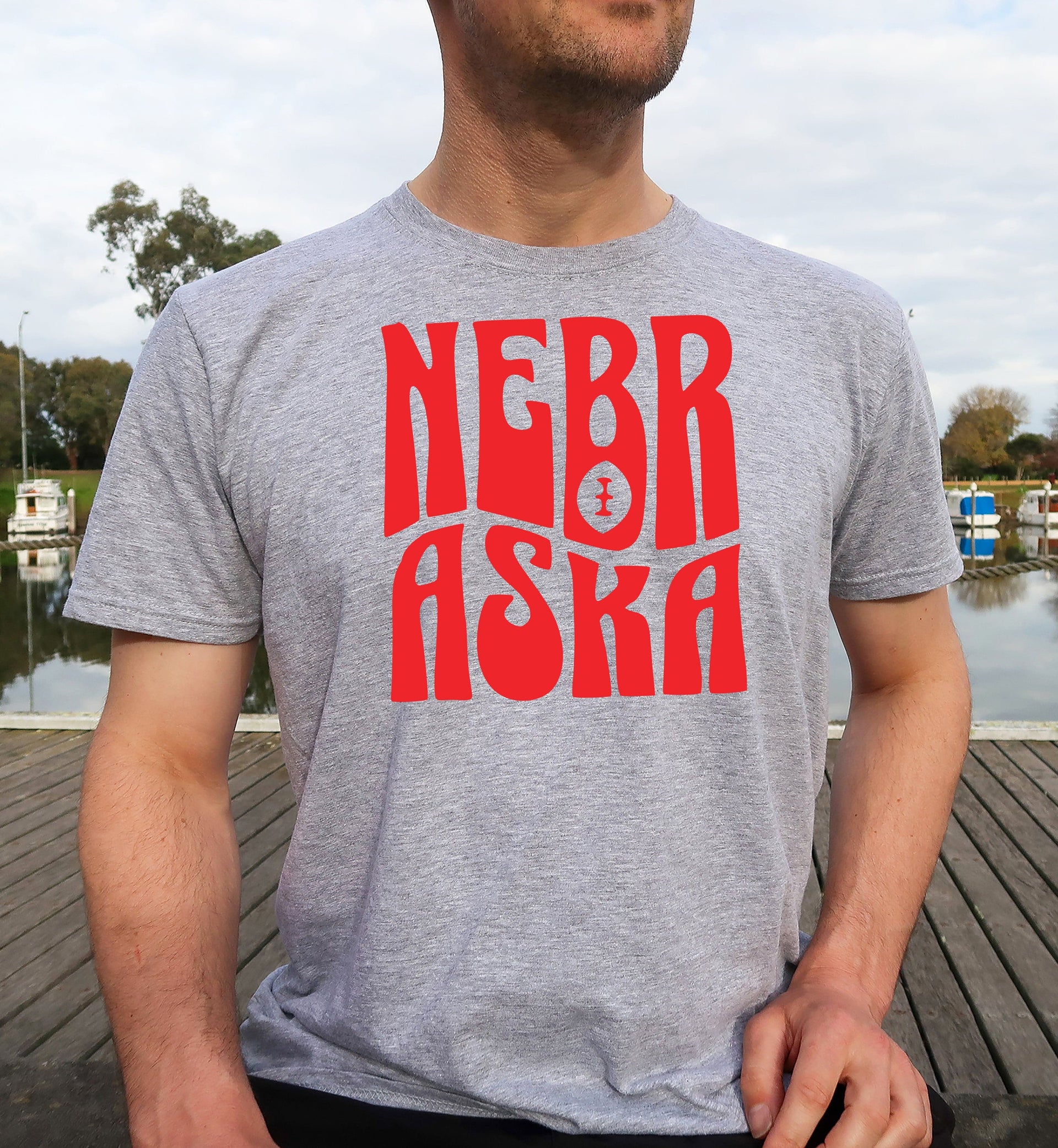 Man wearing a sport grey retro Nebraska t-shirt.