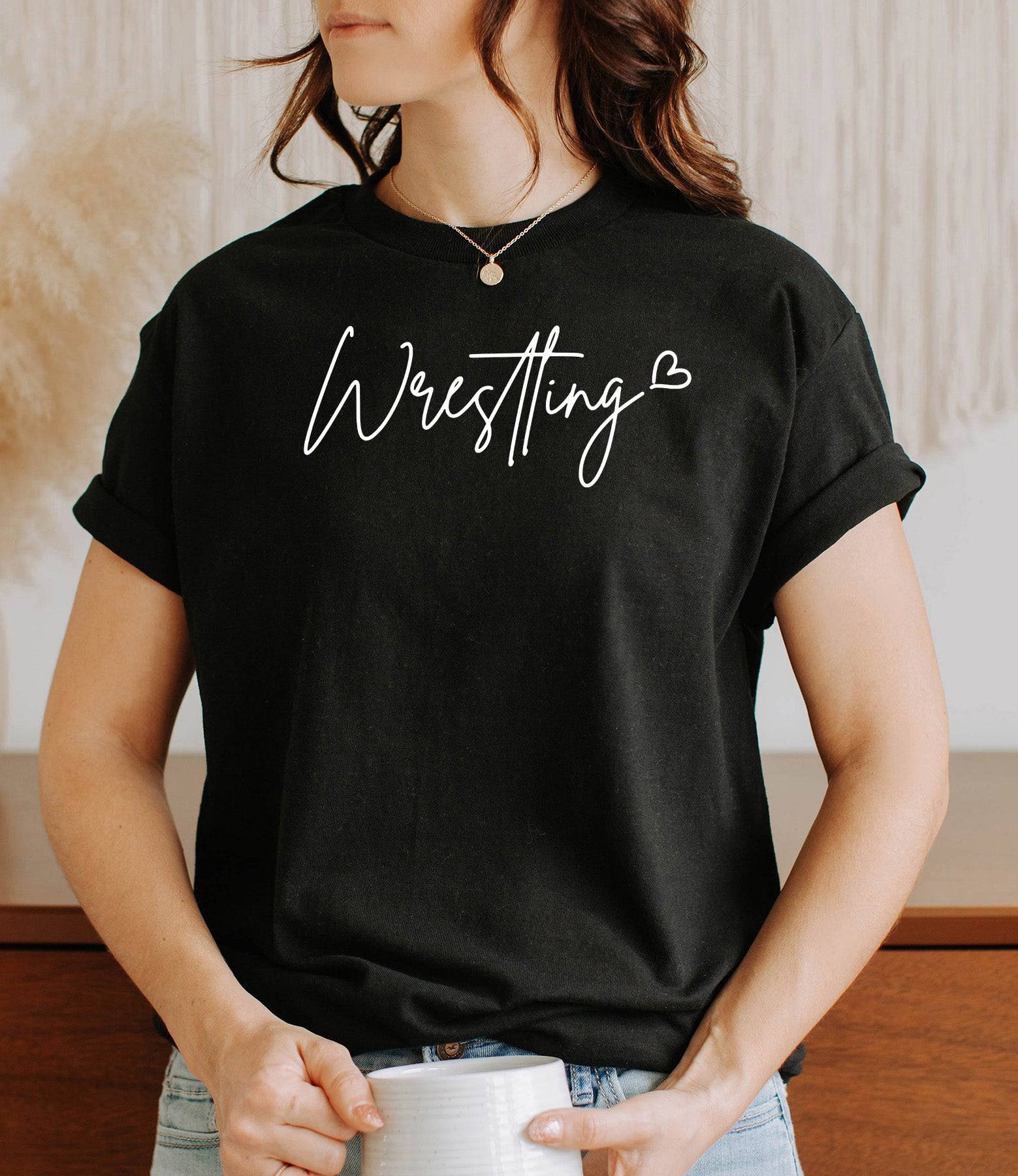 Woman wearing a black Wrestling Love t-shirt.