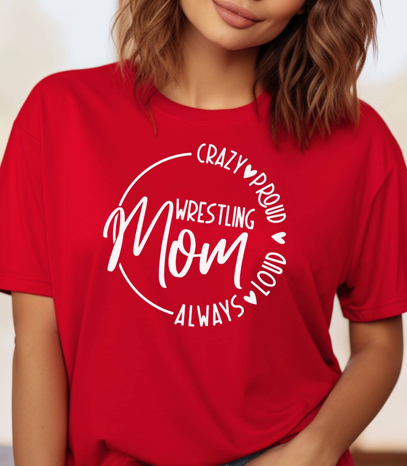 Woman wearing a red t-shirt that says "Wrestling Mom Crazy Proud Always Loud."