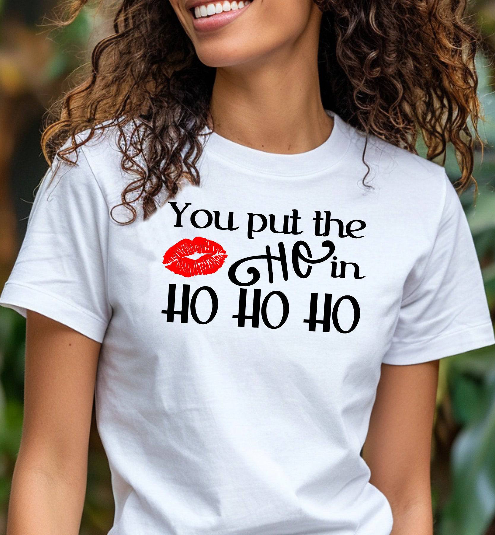 A woman wearing a white t-shirt that says "You Put the Ho in Ho Ho Ho."
